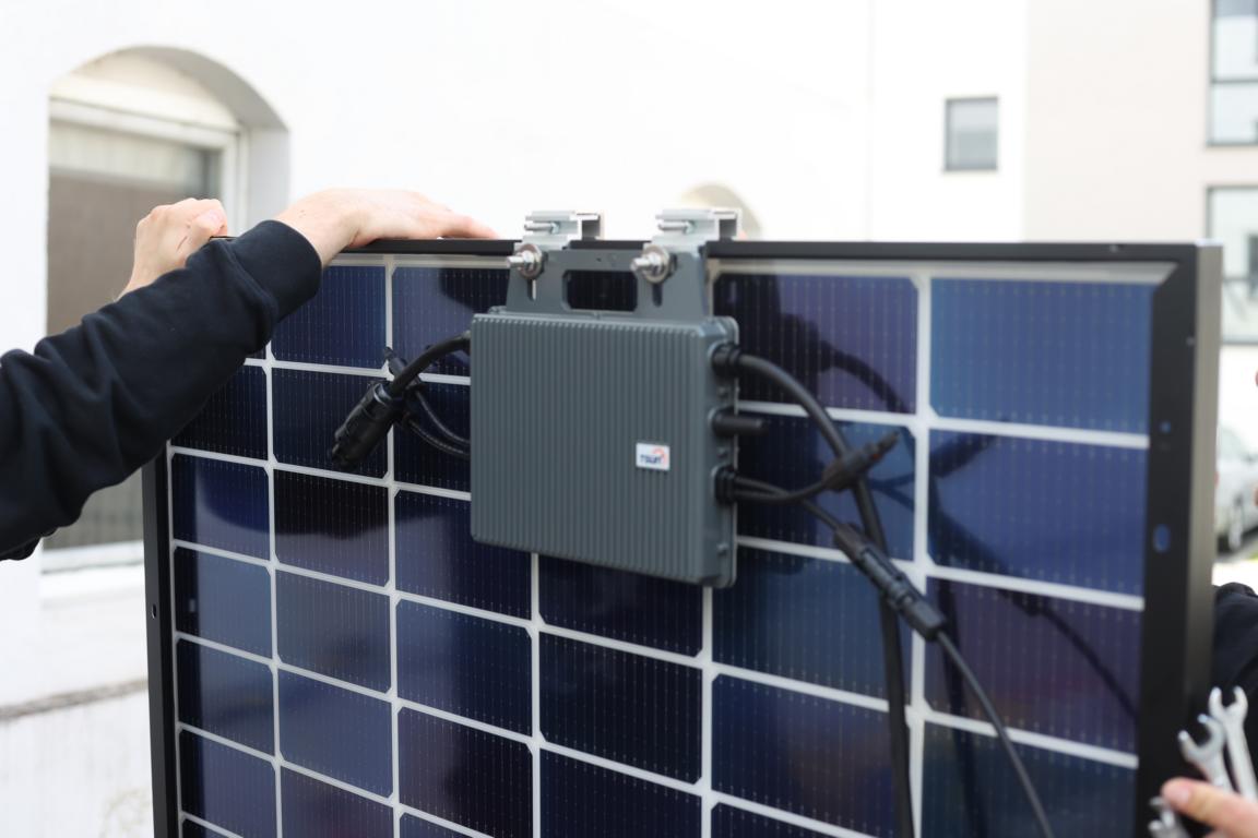 Der TSUN MS600 Wechselrichter ist an der Rückseite des bifazialen Solarmoduls des Solakon Balkonkraftwerks befestigt.